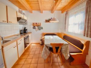 a small kitchen with a table and a sink at Ferienhaus Regent in Regen