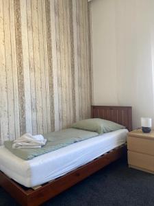 a bed in a room with a wall at Apartment KLASSIKO in Bremerhaven