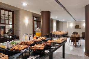a buffet line with many different types of food at Eurostars das Artes in Porto