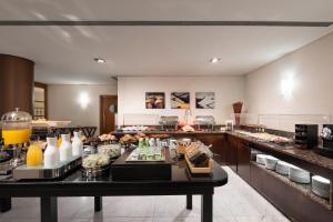 a restaurant with a buffet line with food on display at Eurostars das Artes in Porto