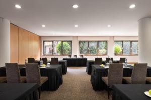 a conference room with tables and chairs and windows at Eurostars das Artes in Porto
