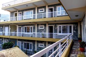 an external view of a building with balconies at Hotel Homeland and Restaurant in Pokhara