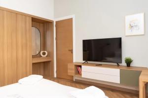 a living room with a television and a bed at Brassbell apartments in Downtown Talaat Harb street in Cairo