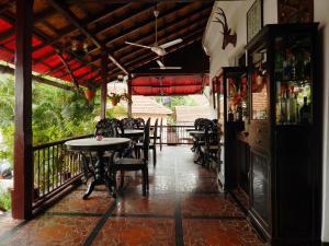 a restaurant with tables and chairs on a balcony at WelcomHeritage Panjim Inn in Panaji