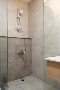 a bathroom with a shower with a glass door at Brassbell apartments in Downtown Talaat Harb street in Cairo
