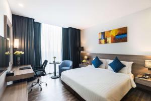 a hotel room with a bed and a desk at Best Western Plus Wanda Grand Hotel in Nonthaburi
