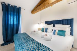 a bedroom with a large bed with blue curtains at Residence Meynadier - apartments - New - AC - Wifi - Close Beach and Palais - LRA Cannes in Cannes +31 photos