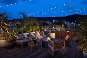 a patio with couches and a table on a deck at night at NOHGA HOTEL KIYOMIZU KYOTO in Kyoto