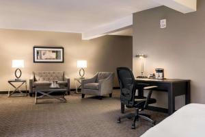 a living room filled with furniture and a large window at Wyndham Springfield City Centre in Springfield