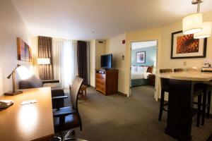 a hotel room with a desk and a room with a bed at Sonesta ES Suites Austin The Domain Area in Austin