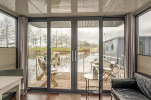 a living room with sliding glass doors at Tiny Hanzeboat in Hattem