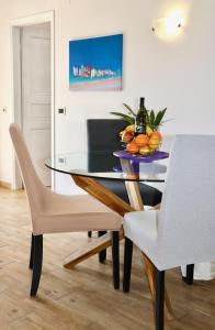 comedor con mesa de cristal y sillas en Apartment Maestral, en Rovinj