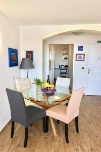 a dining room with a glass table and chairs at Apartment Maestral in Rovinj