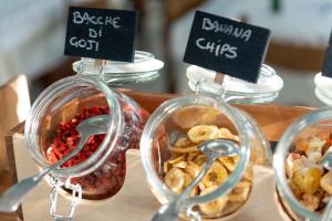 a display of different types of food in glass jars at Hotel Capitano in Tortoreto Lido