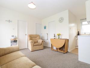 a living room with a couch and a chair at 14 Siesta Mar in Norwich +16 photos