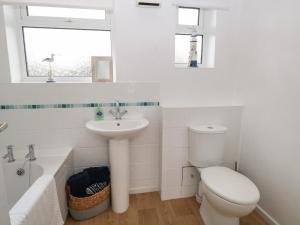 a white bathroom with a sink and a toilet at 14 Siesta Mar in Norwich
