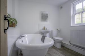a white bathroom with a sink and a toilet at Brook Cottage Green - 2 Bedroom Cottage - Dale in Dale