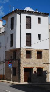 a large white building with windows on a street at Casa Rural Carmen Atzeneta in Adzaneta