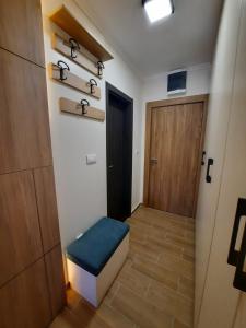 a hallway with a blue stool and a door at Apartman Radmila in Kopaonik +23 photos