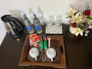a wooden box with drinks and snacks on a table at Sun Moon Hotel in Loei