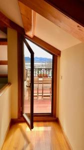 a room with a large glass door to a balcony at A Casa Do Patín Cangas in Cangas de Morrazo