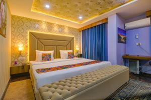 A bed or beds in a room at FabHotel Prime Z Grand
