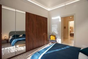 A bed or beds in a room at VITTORIO EMANUELE HOUSE