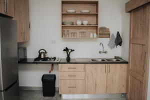 a kitchen with wooden cabinets and a sink at Pretorius Park in Hartbeespoort