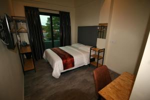 Ліжко або ліжка в номері Pangkor Pop Ash Hotel