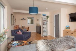 a living room with a blue couch and a table at Croft4 in Broadford