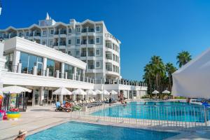 a hotel with a swimming pool in front of a building at Royal Atlantis Beach in Side