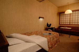 Postel nebo postele na pokoji v ubytování Hotel Iida