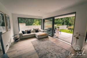 a living room with a couch and a large glass door at La Perla in Lindau