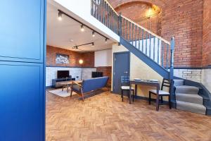 an office with a staircase and a table and chairs at No 8 at Simpson Street Apartments Sunderland in Sunderland