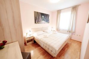 Postel nebo postele na pokoji v ubytování Villa Alma