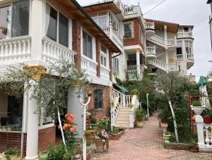a row of houses with flowers on a brick sidewalk at Villa Gersina Golem in Golem