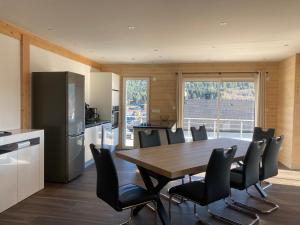 a kitchen and dining room with a table and chairs at Chalet Jersey in Gérardmer