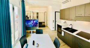 a kitchen with a table and chairs and a tv at Bonaventura in Porto Cesareo