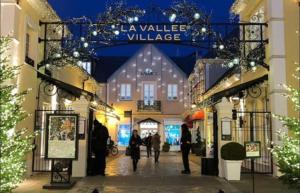 a group of people walking down a street with christmas lights at Studio Disneyland Paris Holidays in Montévrain