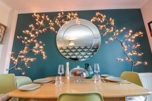 a dining room with a table and a mirror at Coastguard Cottage in Rye