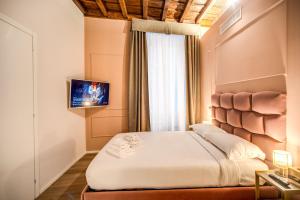 Capranica Private Suites客房内的一张或多张床位