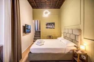 Capranica Private Suites客房内的一张或多张床位