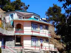 a man standing in front of a building at Deelux cottages inn in Chail