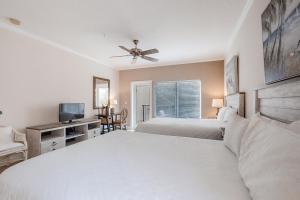 a bedroom with two beds and a ceiling fan at Dog-Friendly Tennis Villa Suite in Amelia Island w/Shared Pool, Free WiFi in Fernandina Beach +8 photos