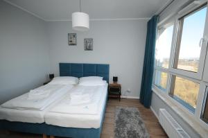 グダニスクにあるApartament Horyzontのベッドルーム1室(ベッド1台、大きな窓付)