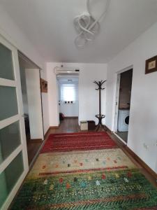 a hallway with a rug on the floor and a ceiling at Casa Anton Buzău in Buzău