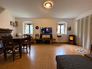 a living room with a table and a tv at Rustico Lo Scarpone in Camaiore