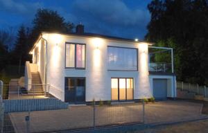 a large white house with lights on top of it at Ferienvilla mit Panoramablick auf den Schmachter See in Binz