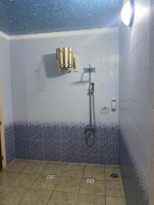 a bathroom with a shower with a shower head at Гостиница ОАЗИС in Atyraū