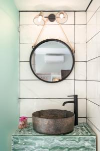 a bathroom with a sink and a mirror at Flores Playa in Matala